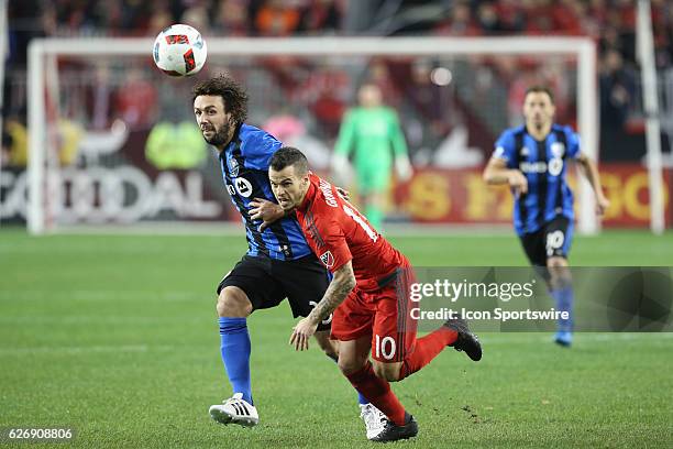 Toronto FC forward Sebastian Giovinco battles for the ball against Montreal Impact defender Marco Donadel during the MLS Conference Final Leg 2 on...