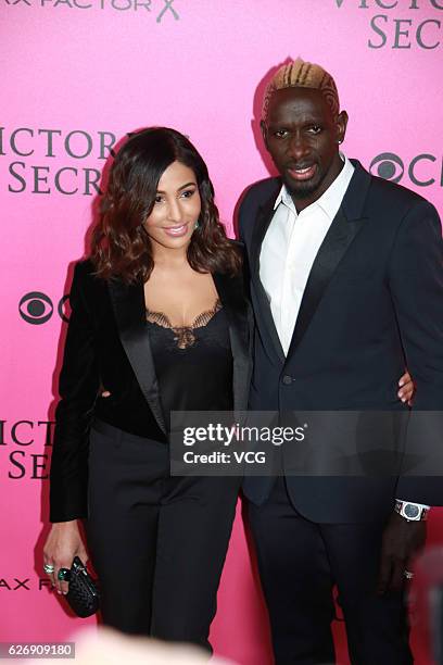 Football player Mamadou Sakho and his wife Majda arrives at the pink carpet of the 2016 Victoria's Secret Fashion Show at Le Grand Palais on November...