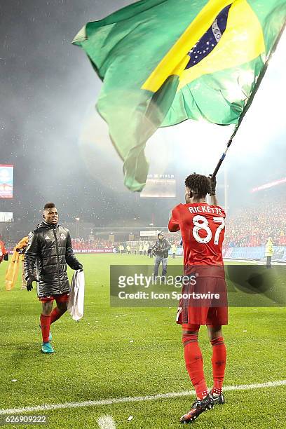 Tosaint Ricketts of the Toronto FC waves the Brazilian flag after defeating the Montreal Impact 5-2 to capture the Eastern Conference Championship on...