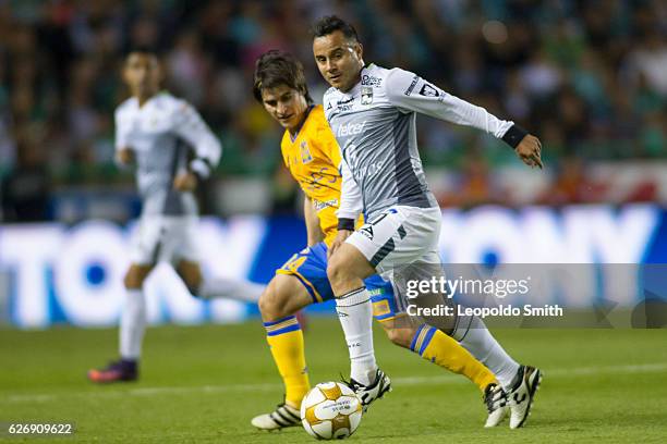 Luis Montes of Leon fights for the ball with Jorge Estrada of Tigres during the semifinals first leg match between Leon and Tigres UANL as part of...