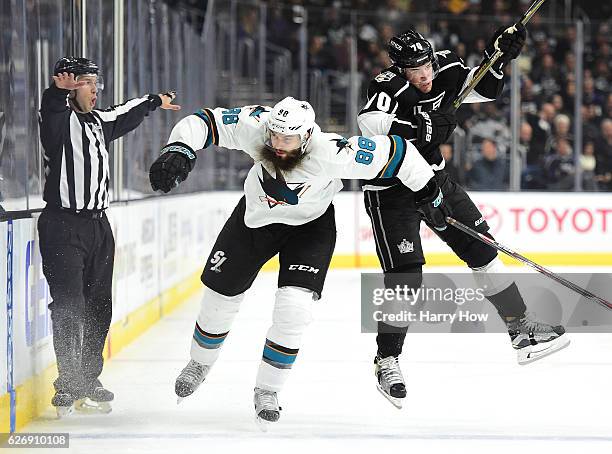 Tanner Pearson of the Los Angeles Kings takes a check from Brent Burns of the San Jose Sharks during the second period at Staples Center on November...