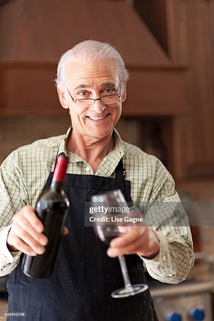 Senior man having a glass of wine