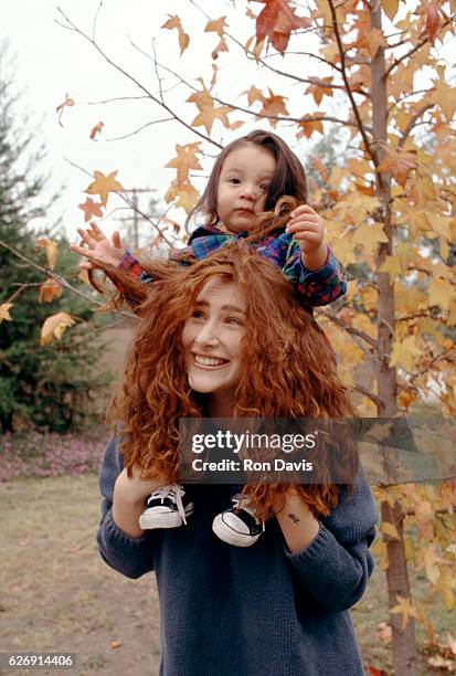 American singer and songwriter Tiffany poses for a portrait with her son Elijah circa 1993 in Los Angeles, California.