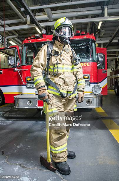 full shot of fireman wearing full protection equipment and truck - fireman axe stock pictures, royalty-free photos & images