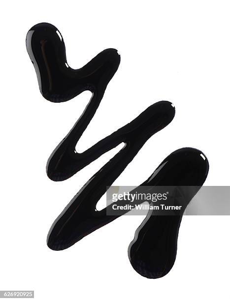 a close up image of black nail polish. - black nail polish stock pictures, royalty-free photos & images