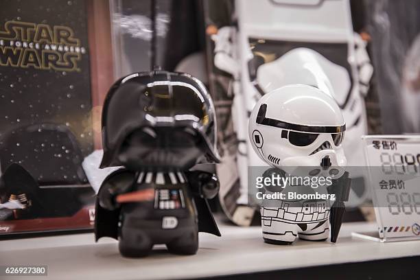 Toy figurines of Darth Vader and a Stormtrooper character from the "Star Wars" film franchise are displayed at an Mtime.com Inc. Kiosk in Beijing,...