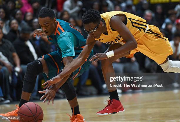 Gwynn Park's Justin Faison, right, reaches for the ball as Westlake's Everett Mouton almost knocks it away during the Maryland 2A South Region boys'...