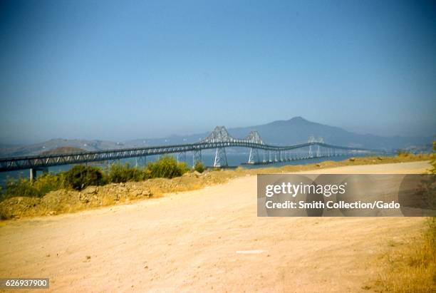 The Richmond San Rafael Bridge as seen from dirt road near the shoreline, San Rafael, California, 1955. .