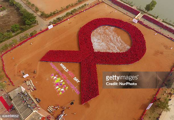 Students of the KISS stand in a human chain as they build Red Ribbon logo of HIV AIDs and make the Guinness Book of World record in the eastern...