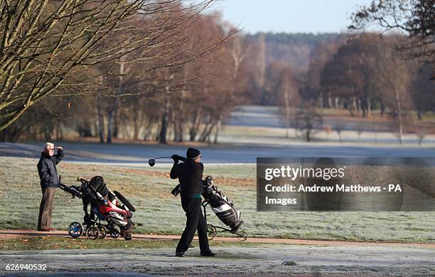 Golfers tee off on a frost covered tee at Hartley Wintney Golf Club in Hampshire, with today marking the official start of meteorological winter as...