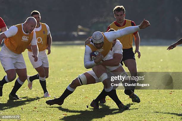 Dave Attwood is tackled during the England training session held at Pennyhill Park on December 1, 2016 in Bagshot, England.