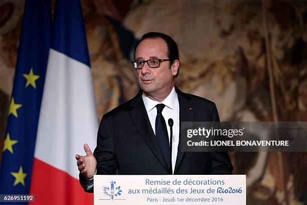French President Francois Hollande delivers a speech after awarding the Legion of Honour to Olympic and Paralympic athletes at the Elysee...