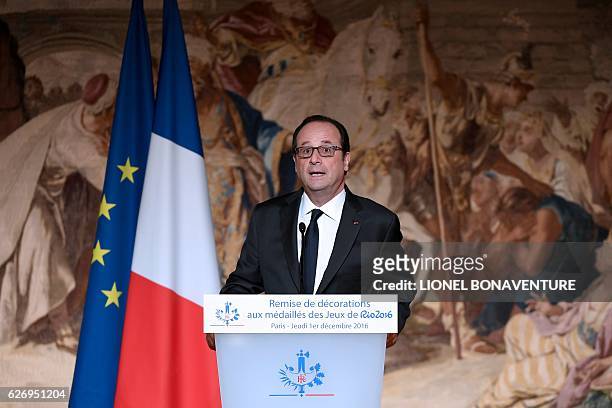 French President Francois Hollande delivers a speech after awarding the Legion of Honour to Olympic and Paralympic athletes at the Elysee...