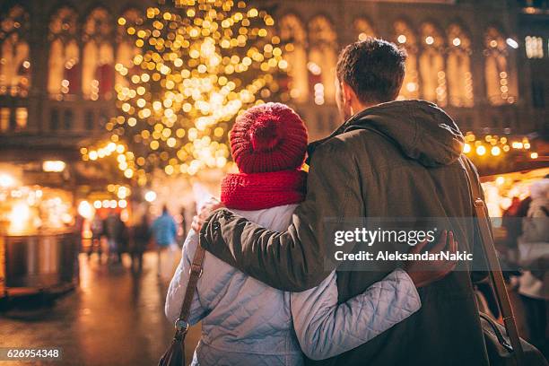 romance on christmas market - christmas tree outside stock pictures, royalty-free photos & images