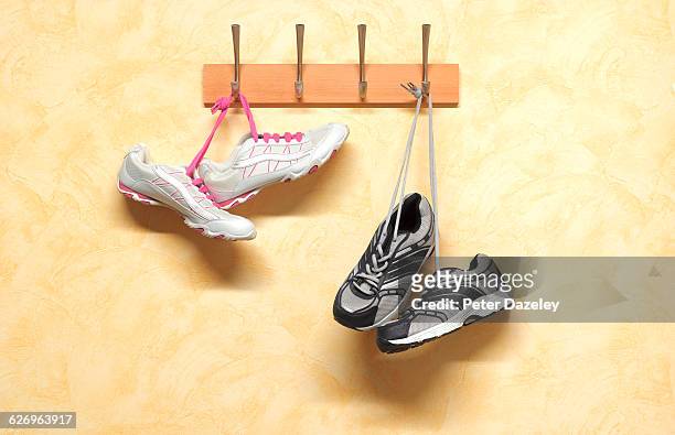 his and hers keep fit trainers - coat stand stock pictures, royalty-free photos & images