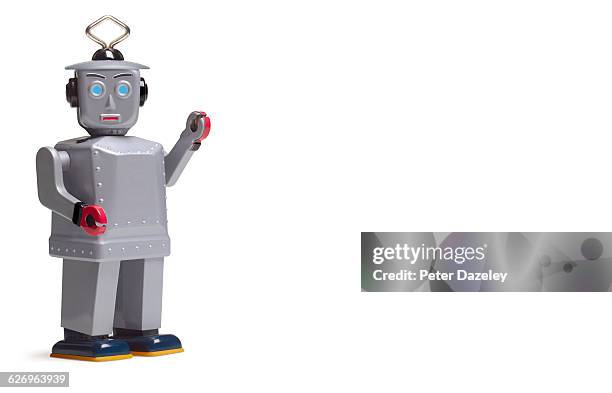 studio shot of silver robot with copy space - toy robot stock pictures, royalty-free photos & images