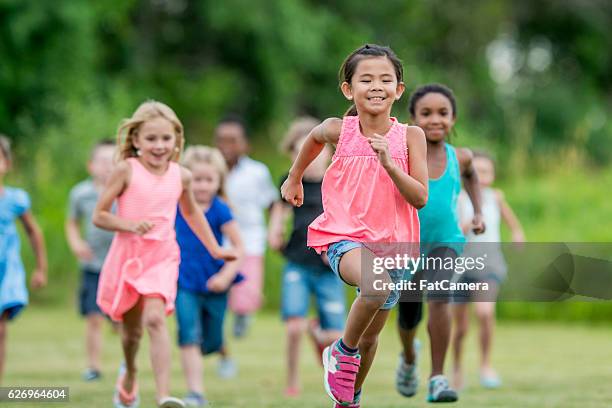 running outside during recess - playing tag stock pictures, royalty-free photos & images