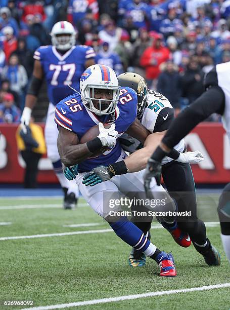 LeSean McCoy of the Buffalo Bills is tackled by Paul Posluszny of the Jacksonville Jaguars as he carries the ball during NFL game action at New Era...