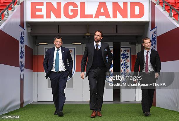 Chief Executive Martin Glenn and FA Technical Director Dan Ashworth walk alongside Gareth Southgate as he is unveiled as the new England manager at...