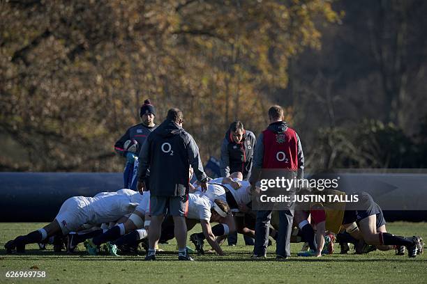 England players practice scrummaging during a team training session at their Pennyhill Park factility in Bagshot, south-east England on December 1...