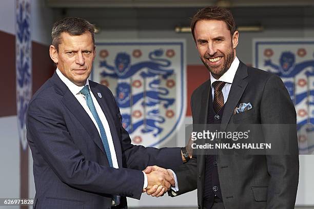 Chief Executive Martin Glenn shakes hands with England's new manager Gareth Southgate for photographers during a media session at Wembley stadium in...