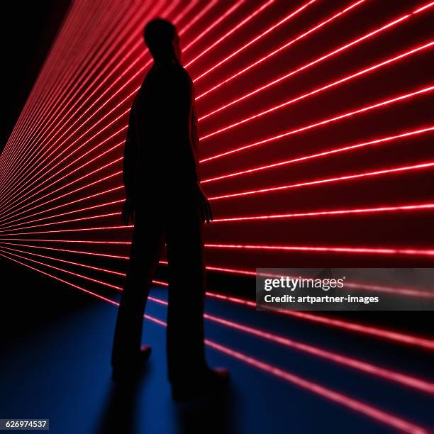 man standing in front of laser - red square stock-fotos und bilder