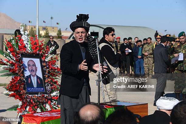 Afghan President Ashraf Ghani speaks after paying respects at the funeral service of commander of the 207th Corps, General Mohayedin Ghori in Herat...