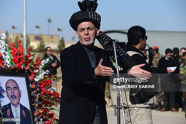 Afghan President Ashraf Ghani speaks after paying respects at the funeral service of commander of the 207th Corps, General Mohayedin Ghori in Herat...