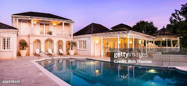 luxury villa at twilight - barbados stock-fotos und bilder