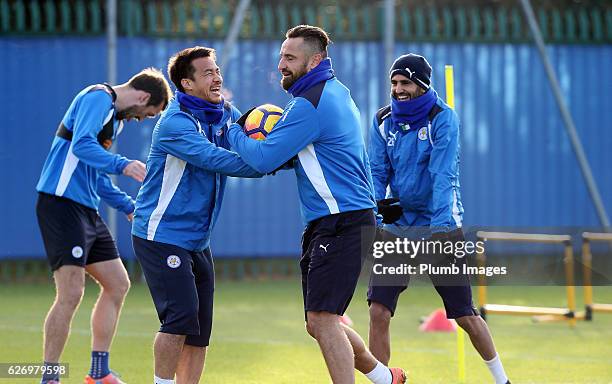 Marcin Wasilewski shares a joke with Shinji Okazaki and Riyad Mahrez during a Leicester City training session at Belvoir Drive Training Complex on...