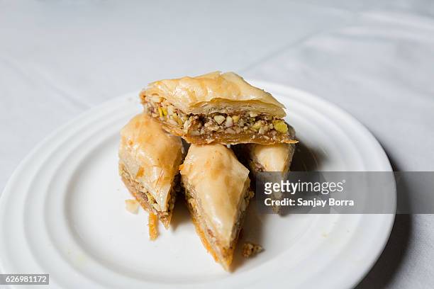 close-up of baklava, a dessert made with filo pastry and chopped nuts and sugar syrup.it is a popular turkish dessert - baklava stock pictures, royalty-free photos & images