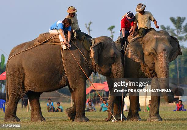 Elephant polo players from Irelephants and Himalyan Tiger Foundation vie for the ball during the 35th International Elephant Polo Competition at...