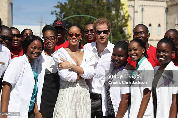 Rihanna and Prince Harry pose with volunteers at the 'Man Aware' event held by the Barbados National HIV/AIDS Commission on the eleventh day of an...