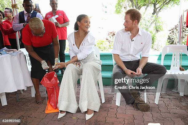 Prince Harry watches as Singer Rihanna gets her blood sample taken for an live HIV test, in order to promote more widespread testing for the public...