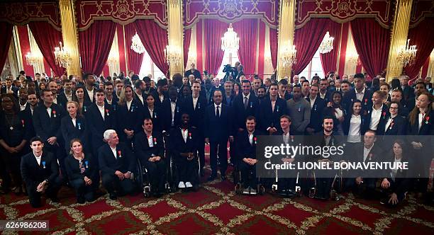 French President Francois Hollande stands amongst Olympic and Paralympic athletes after awarding them the Legion of Honour at the Elysee Presidential...