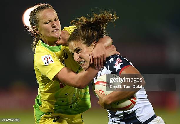 Ryan Carlyle of United States and Emma Sykes of Australia battle for the ball during day one of the Emirates Dubai Rugby Sevens - HSBC World Rugby...