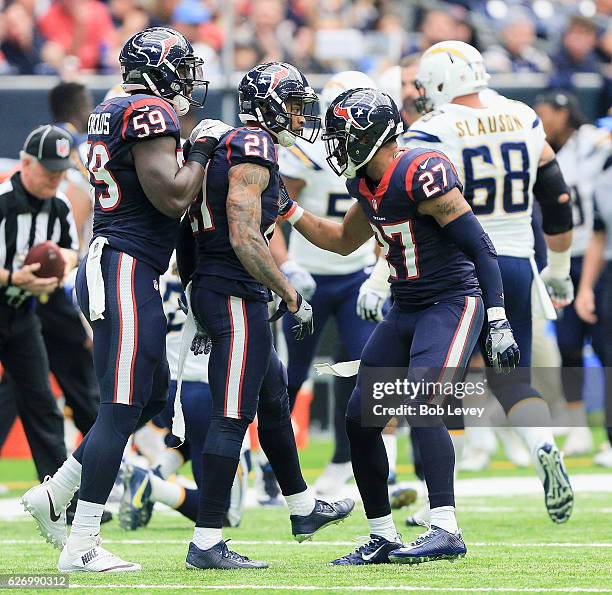 Whitney Mercilus of the Houston Texans, A.J. Bouye and Quintin Demps celebrate after a defensive stop against the San Diego Chargers at NRG Stadium...