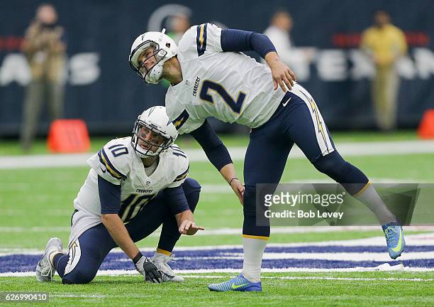 Josh Lambo of the San Diego Chargers and Kellen Clemens watch as a field goal attempt goes wide against the Houston Texans at NRG Stadium on November...