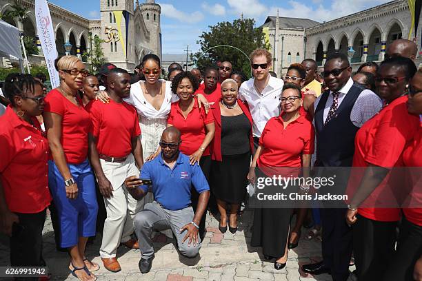 Rihanna and Prince Harry pose with volunteers at the 'Man Aware' event held by the Barbados National HIV/AIDS Commission on the eleventh day of an...