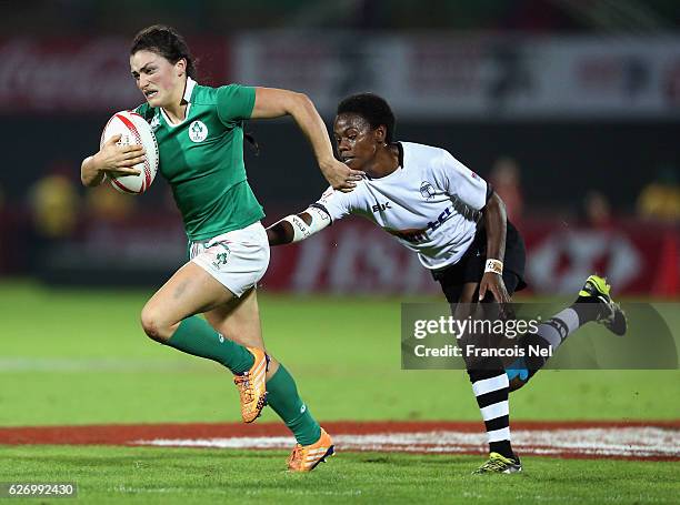 Lucy Mulhall of Ireland is tackled by Raijieli Daveua of Fiji during day one of the Emirates Dubai Rugby Sevens - HSBC World Rugby Women's Sevens...