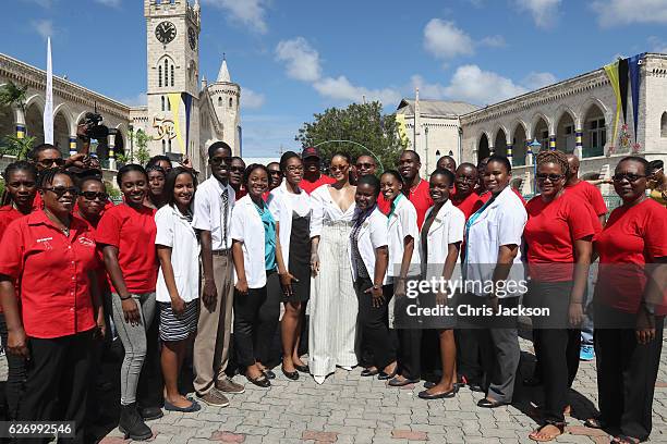 Rihanna poses with volunteers at the 'Man Aware' event held by the Barbados National HIV/AIDS Commission on the eleventh day of an official visit on...