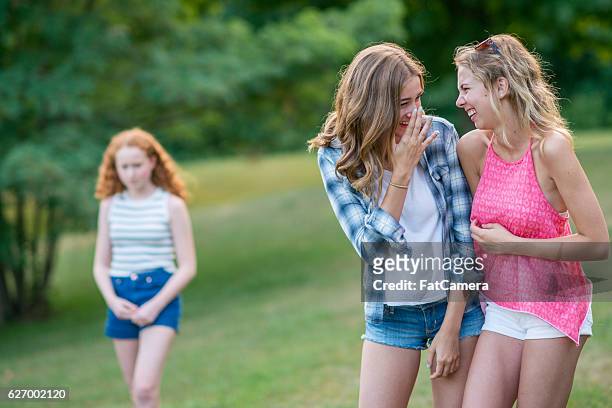 teenage girls gossiping - cruel stock pictures, royalty-free photos & images