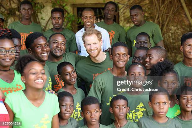 Prince Harry poses with volunteers at 'Nature Fun Ranch' on the eleventh day of an official visit on December 1, 2016 in St Andrew, Barbados. The...