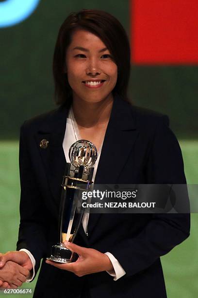 Chan Yuen-ting, manager of Hong Kong's Eastern Athletic Association football team, receives a trophy after being named the AFC Women's Coach of the...