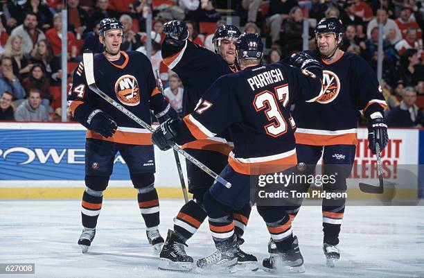 Left wing Shawn Bates and right wing Mark Parrish of the New York Islanders celebrate a goal during the game against the Detroit Red Wings at the Joe...