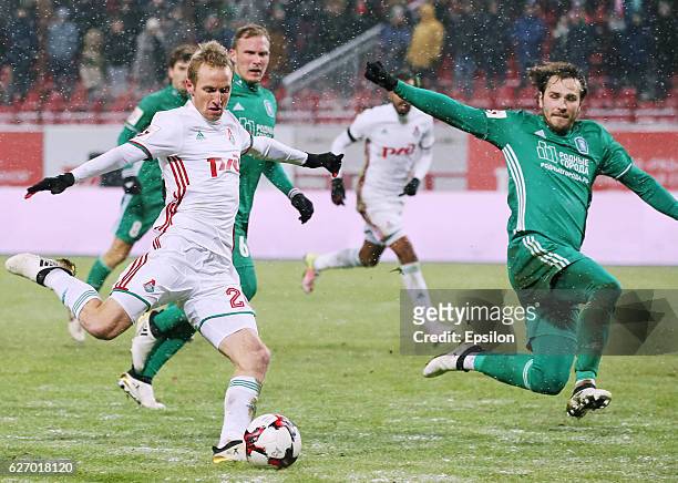 Vitaly Dyakov of FC Tom Tomsk and Vladislav Ignatyev of FC Lokomotiv Moscow vie for the ball during the Russian Football League match between FC Tom...