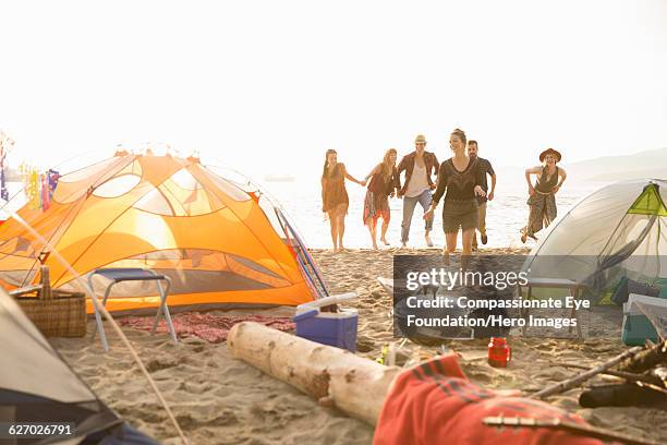 friends playing on beach - 127th anniversary of congress party foundation day stockfoto's en -beelden