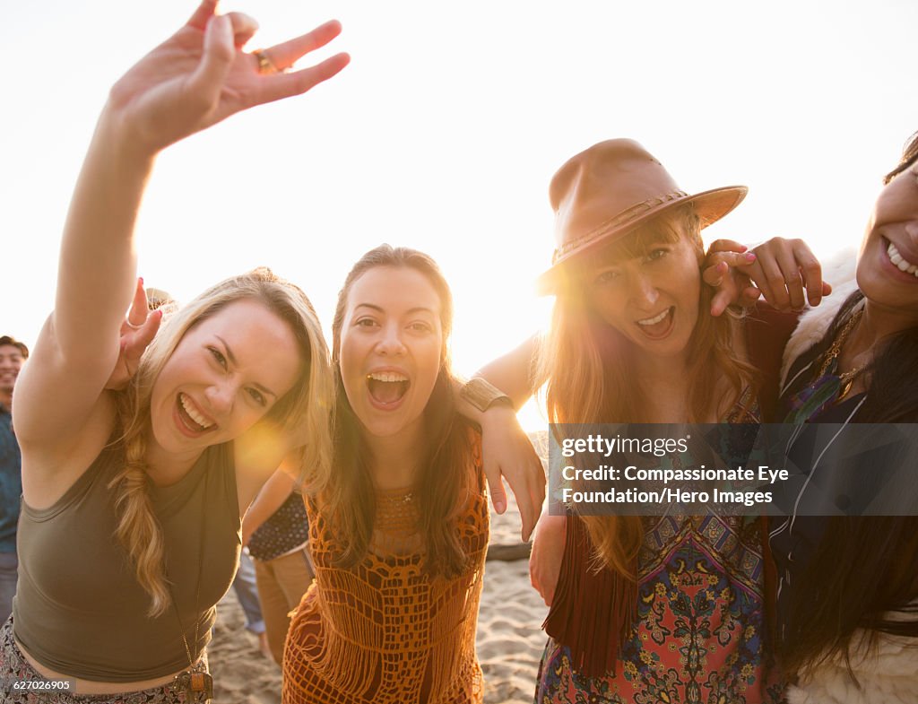 Smiling friends hanging out on beach