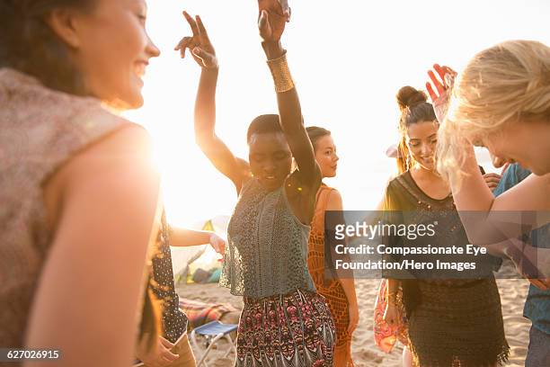 friends enjoying dancing on beach - vancouver sunset stock pictures, royalty-free photos & images
