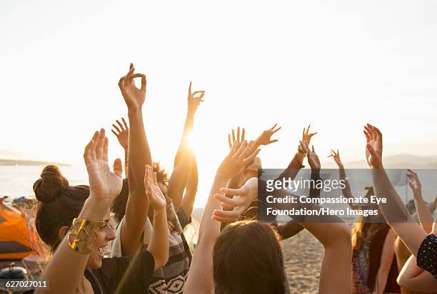 friends enjoying dancing on beach - party sulla spiaggia foto e immagini stock